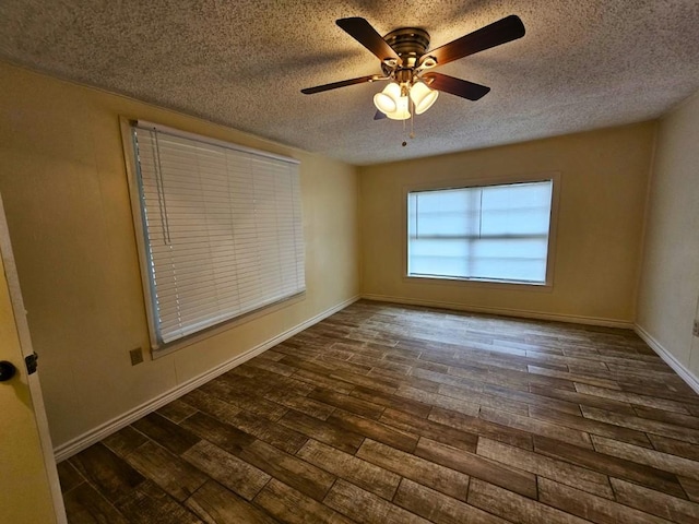 unfurnished room with dark wood-type flooring, ceiling fan, and a textured ceiling