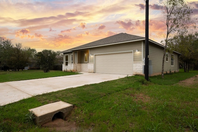 view of front of house featuring a garage and a yard