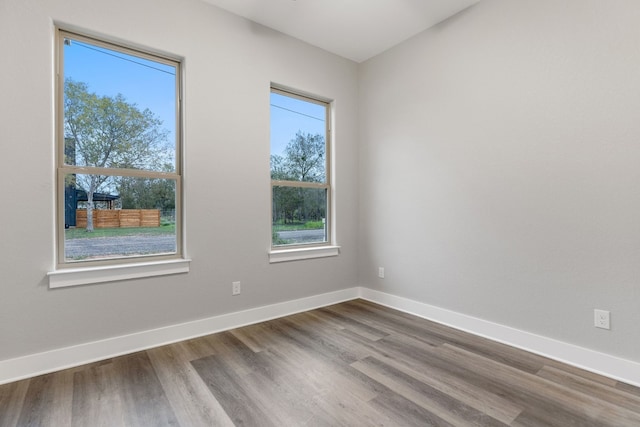 unfurnished room with hardwood / wood-style flooring