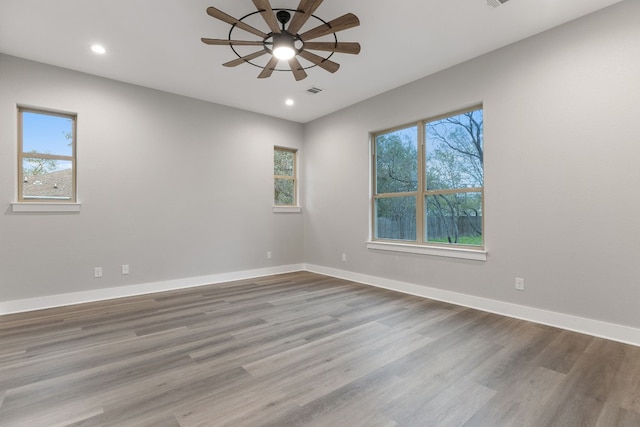 empty room with hardwood / wood-style flooring and ceiling fan