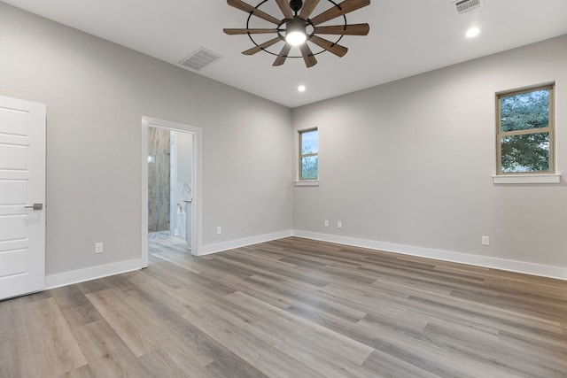 empty room featuring ceiling fan and light wood-type flooring