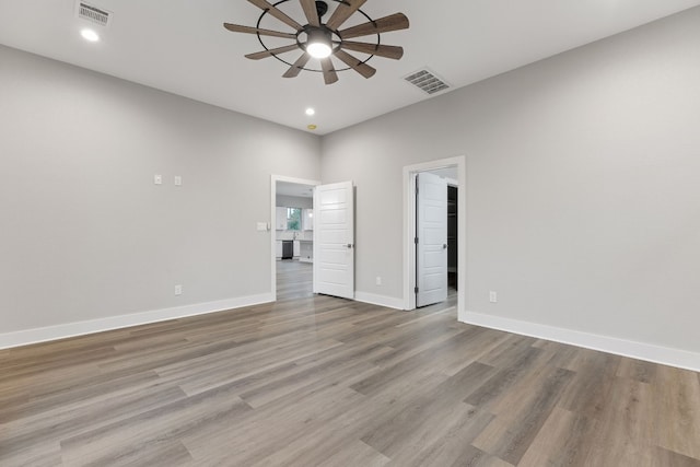 spare room featuring ceiling fan and light hardwood / wood-style flooring