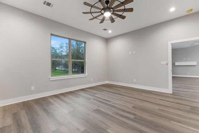 spare room with ceiling fan and hardwood / wood-style floors