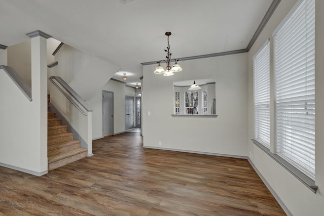 interior space featuring crown molding, hardwood / wood-style flooring, and a chandelier