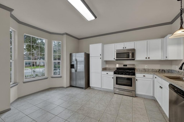 kitchen featuring decorative light fixtures, ornamental molding, stainless steel appliances, and white cabinets