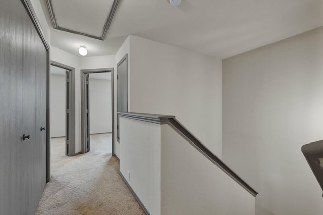 hallway with light colored carpet