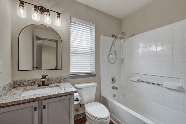 full bathroom with shower / bathing tub combination, vanity, plenty of natural light, and toilet