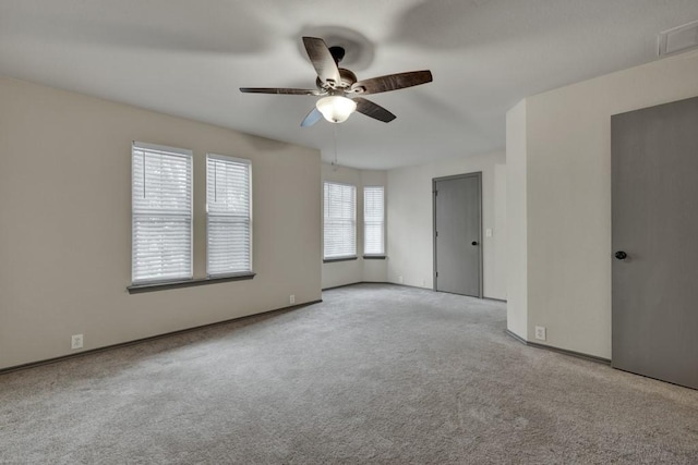 spare room with light colored carpet and ceiling fan