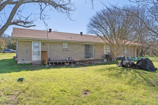 rear view of property with a yard, brick siding, and a patio