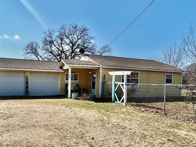 single story home featuring a garage and a front yard