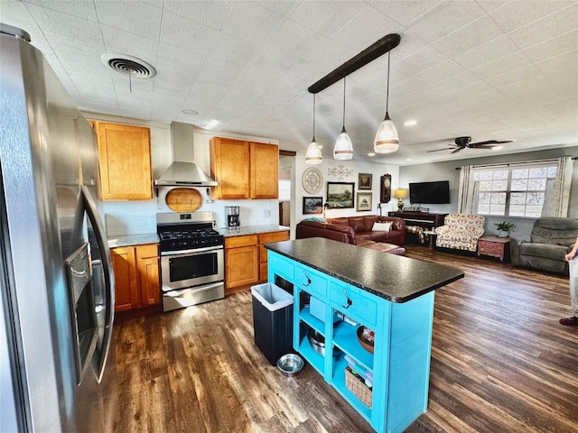 302 E Castlewood Dr, Granite Shoals, TX 78654 - kitchen featuring a kitchen island, appliances with stainless steel finishes, dark hardwood / wood-style floors, pendant lighting, and wall chimney exhaust hood