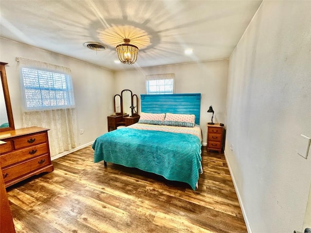 302 E Castlewood Dr, Granite Shoals, TX 78654 - bedroom with dark hardwood / wood-style floors and a chandelier