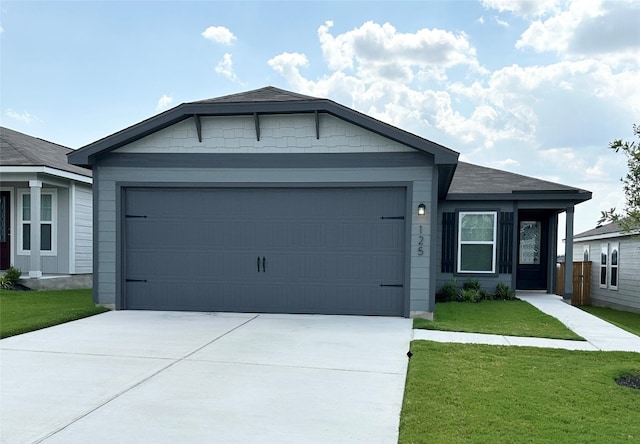 ranch-style house with a garage and a front yard