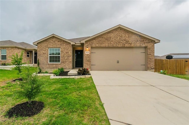 single story home with a garage and a front lawn