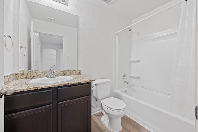 full bathroom with vanity, wood-type flooring, toilet, and shower / bath combination