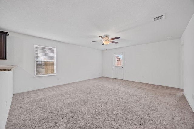 spare room with light carpet and ceiling fan