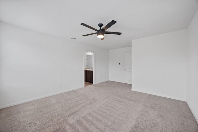 unfurnished room with ceiling fan and light carpet