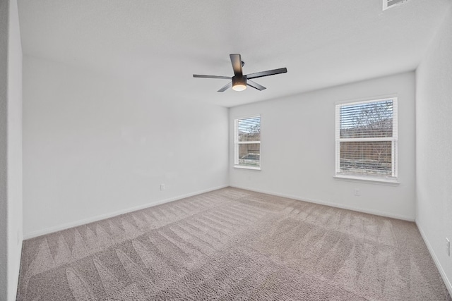 unfurnished room featuring ceiling fan and carpet floors