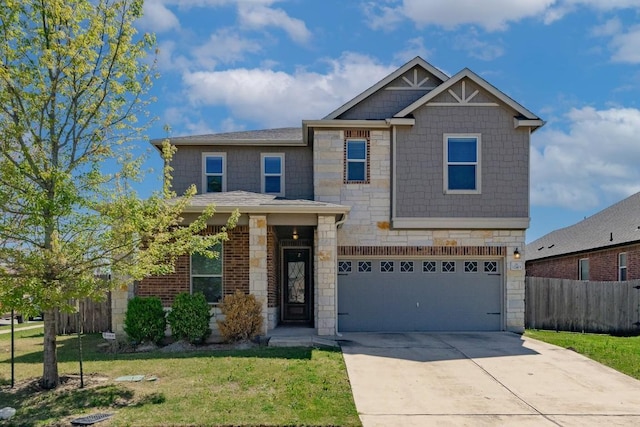 craftsman-style house with stone siding, an attached garage, fence, a front yard, and driveway