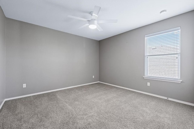 carpeted empty room featuring ceiling fan