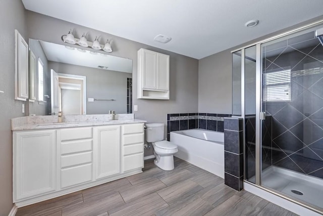 full bathroom with vanity, toilet, independent shower and bath, and plenty of natural light