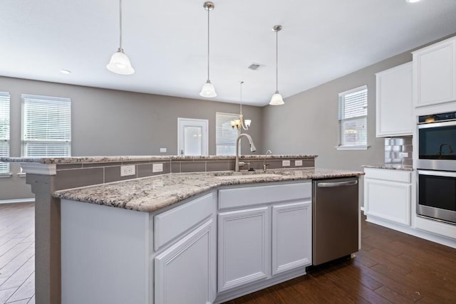 kitchen featuring stainless steel appliances, a kitchen island with sink, sink, and white cabinets