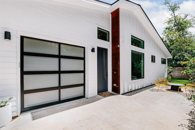 11233/4 Gunter St Unit 2, Austin, TX 78702 - exterior space featuring concrete driveway, a patio area, board and batten siding, and a garage