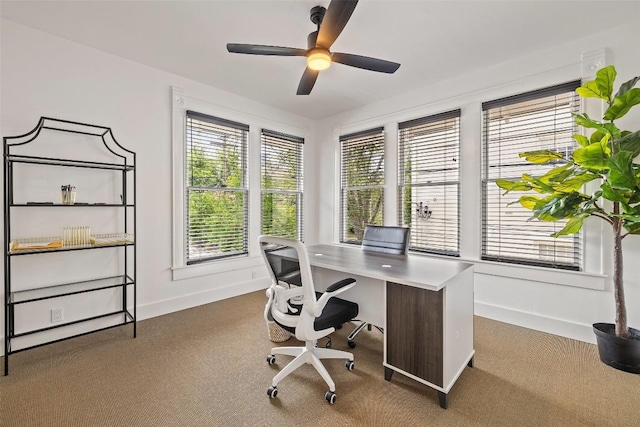 home office with ceiling fan and dark carpet