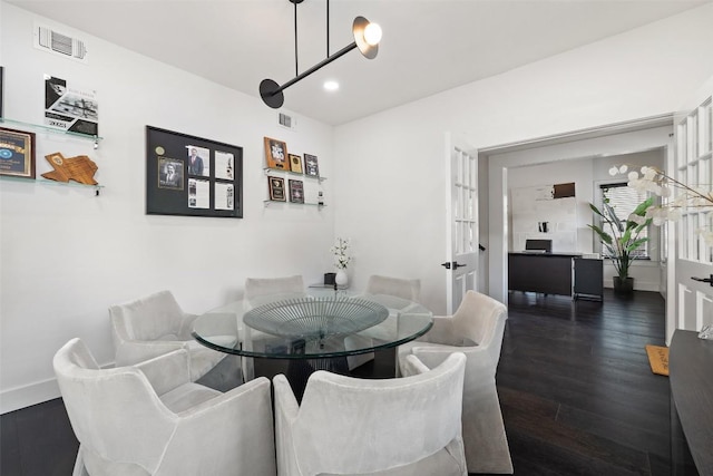 dining area featuring dark wood-type flooring