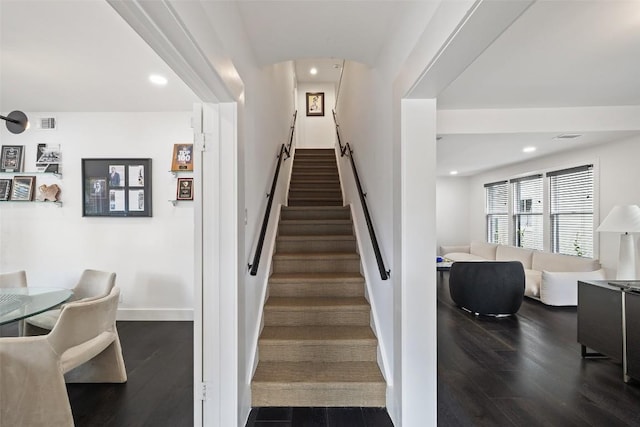 staircase with wood-type flooring