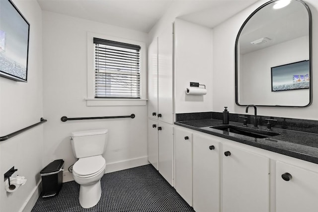 bathroom with vanity, tile patterned floors, and toilet