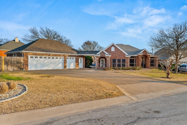 single story home with a garage and a front yard