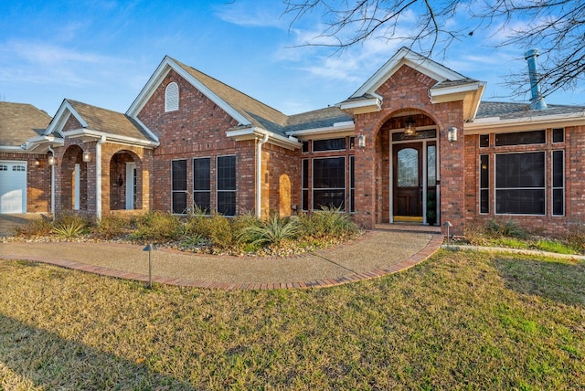 1207 Hyacinth Dr, Temple, TX 76502 - view of front of property with brick siding, a front yard, and a shingled roof
