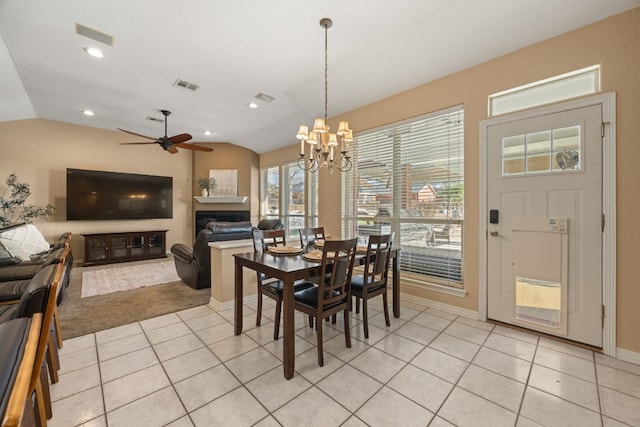 1207 Hyacinth Dr, Temple, TX 76502 - dining space with vaulted ceiling, light tile patterned flooring, a fireplace, ceiling fan, and a chandelier