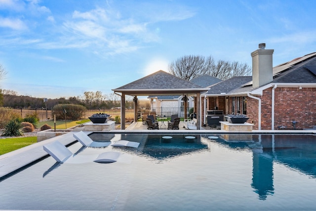 1207 Hyacinth Dr, Temple, TX 76502 - view of swimming pool featuring a gazebo, a fire pit, and a patio area