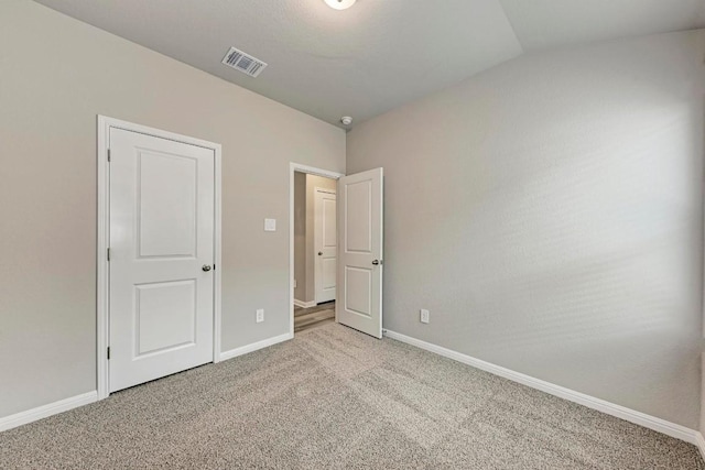 unfurnished bedroom with light colored carpet