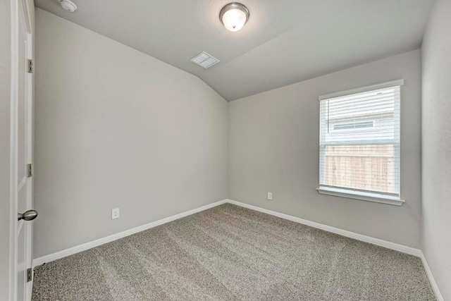 unfurnished room with vaulted ceiling and carpet