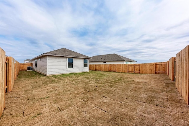 back of property featuring cooling unit and a yard