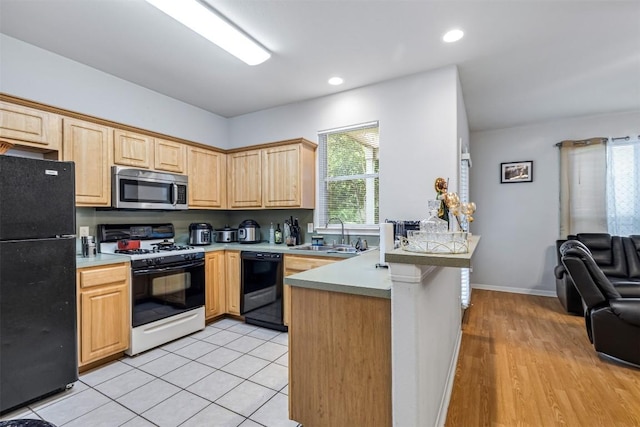 kitchen with light tile patterned flooring, light brown cabinetry, sink, kitchen peninsula, and black appliances