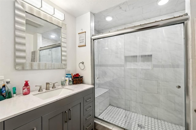 bathroom with an enclosed shower and vanity