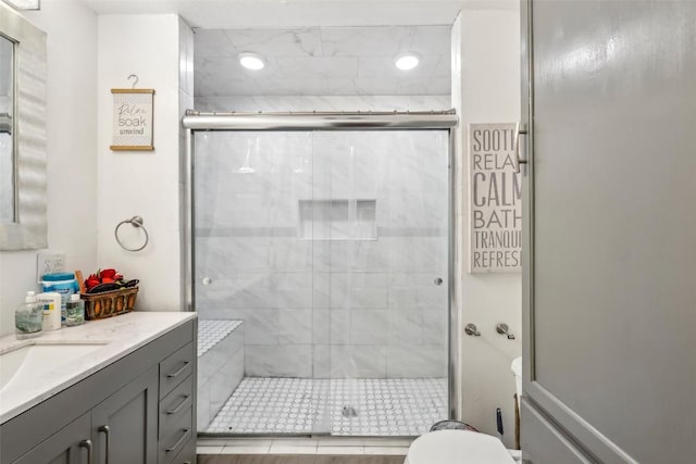 bathroom with vanity, an enclosed shower, and toilet