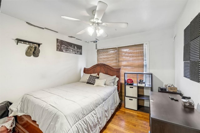 bedroom featuring wood-type flooring and ceiling fan