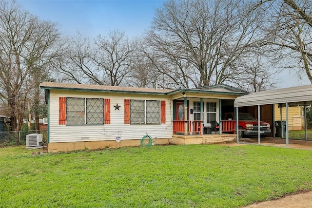 view of front facade with a carport, central AC, and a front lawn