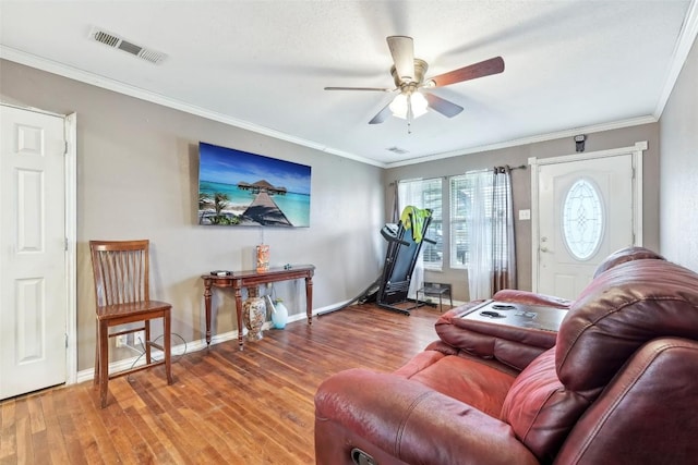 living room featuring ornamental molding, hardwood / wood-style floors, and ceiling fan