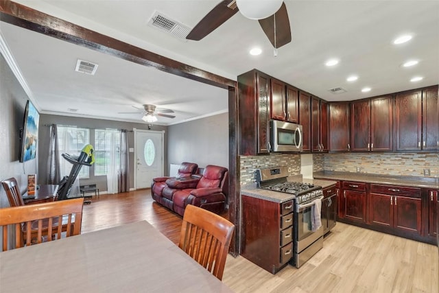 kitchen with crown molding, light hardwood / wood-style flooring, stainless steel appliances, and decorative backsplash