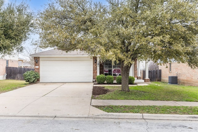 obstructed view of property featuring cooling unit, a garage, and a front yard