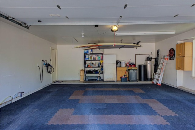465 Hannah Dr, Dripping Springs, TX 78620 - garage featuring freestanding refrigerator and a garage door opener