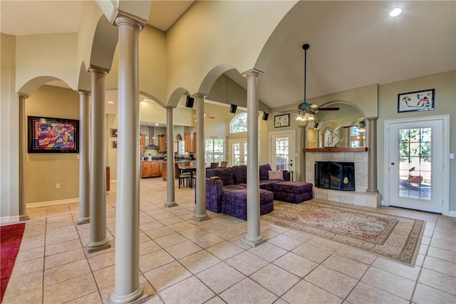 465 Hannah Dr, Dripping Springs, TX 78620 - living area featuring ceiling fan, light tile patterned floors, a tiled fireplace, and a towering ceiling