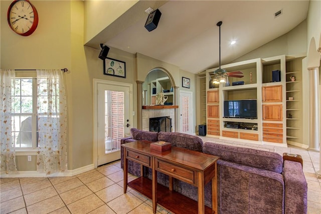 465 Hannah Dr, Dripping Springs, TX 78620 - living area with a fireplace, built in features, light tile patterned floors, high vaulted ceiling, and ceiling fan