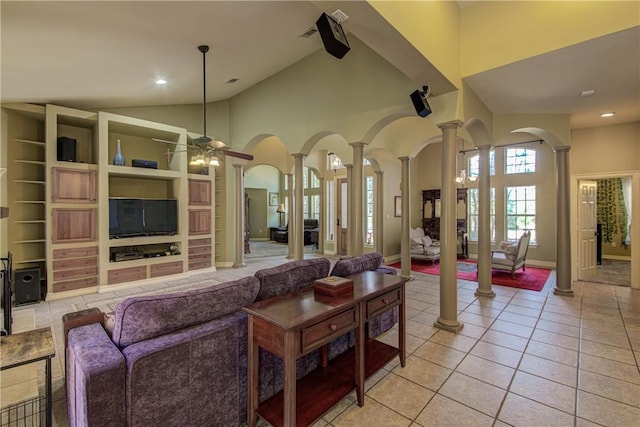 465 Hannah Dr, Dripping Springs, TX 78620 - living room with ornate columns, arched walkways, light tile patterned flooring, a ceiling fan, and high vaulted ceiling